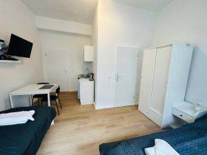 a room with a bed and a table and a desk at Comfortable studio in Berlin5 in Berlin