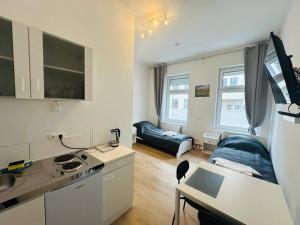 a small apartment with a kitchen and a living room at Comfortable studio in Berlin5 in Berlin
