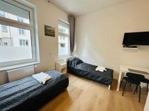 a bedroom with a bed and a desk with a piano at Comfortable studio in Berlin5 in Berlin