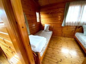 a small room with two beds in a log cabin at Hot Spring Resort Usui Pass Forest Park "Natural H - Vacation STAY 54904v in Karuizawa