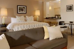 a bedroom with a large bed and a couch at The Hideaway in Palm Springs