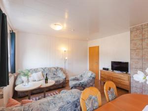 a living room with a couch and a tv at Cosy apartment in Hallenberg near centre in Hallenberg