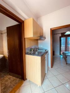 a kitchen with a sink and a counter top at Girogiali Apts in Kissamos