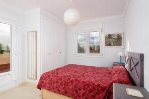 a white bedroom with a bed with a red bedspread at Caddy by ON Travel in Casas Devesa +15 photos