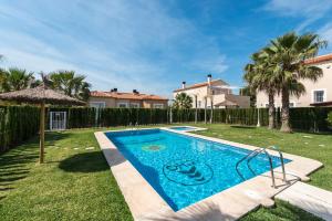 a swimming pool in the backyard of a house at Caddy by ON Travel in Oliva