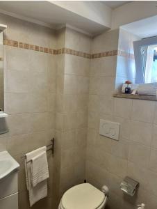 a bathroom with a toilet and a sink at Petite maison in Fiumicino +40 photos