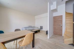 a dining room with a table and chairs and a couch at Les merveilles de la palmyre in Saint-Ciers-sur-Gironde +12 photos