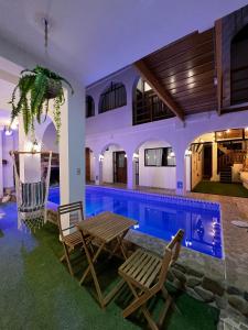 a villa with a swimming pool at night at Gamora Hotel Playa in Los Órganos