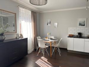 a kitchen with a table and chairs in a room at Apartament Gdynia Park 1 in Gdynia