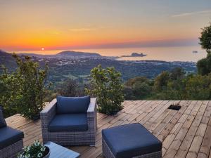 a patio with chairs and a sunset in the background at tre castelli in Monticello