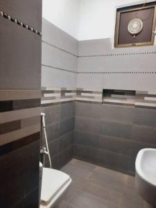 a bathroom with a toilet and a sink at A Exclusive Homes 2 Bed in DHA, Karachi in Karachi
