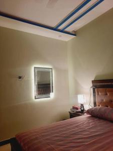 a bedroom with a bed and a mirror on the wall at A Exclusive Homes 2 Bed in DHA, Karachi in Karachi