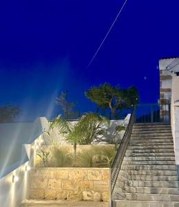 un conjunto de escaleras con palmeras por la noche en Villa Eftychia, en Kissamos