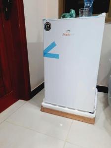 a refrigerator with a blue arrow on the side of it at A Exclusive Homes 2 Bed in DHA, Karachi in Karachi