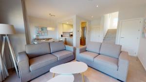 a living room with two chairs and a table at Souvenir by ON Travel in Oliva