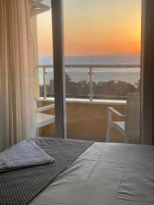 a bedroom with a bed and a view of the ocean at Adil Butik Otel in Didim