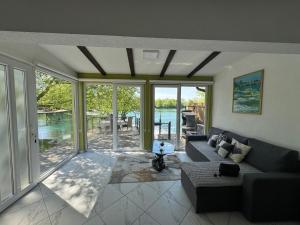 a living room with a couch and a view of the water at Apartman Dzenis in Bihać