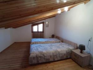 a bedroom with two beds and a window at Μυρτώ in Kalabaka