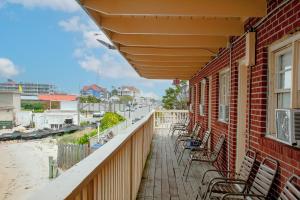 a balcony with chairs on a brick building at Oceanic Motel in Ocean City