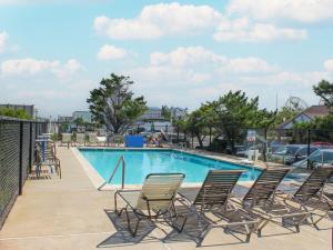 a group of chairs sitting around a swimming pool at Oceanic Motel in Ocean City