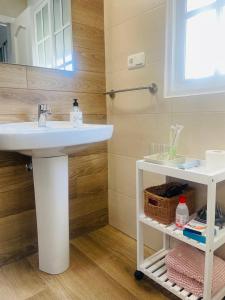 a bathroom with a sink and a mirror at Patio de Los Barberos 3 in Valle de Abdalagís