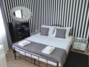 a bedroom with a bed with two towels on it at Apartament BEACH VIBES Nessebar in Nesebar +21 photos