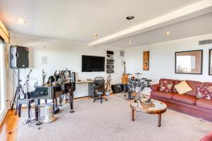 a living room with a couch and a tv at Laguna Beach Getaway with Patio and Clear Ocean Views! in Laguna Beach