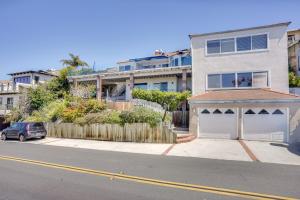 a house with a garage on the side of a street at Laguna Beach Getaway with Patio and Clear Ocean Views! in Laguna Beach