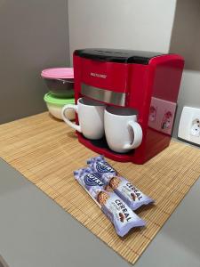 a counter with a coffee maker and two cups on it at Prime Stay - Bela Vista I - São Paulo - BR in Sao Paulo