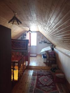 an attic room with a bed and a living room at Баку Шаган дача in Baku