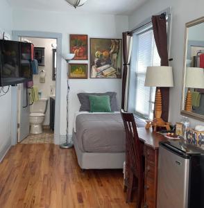 a bedroom with a bed and a desk with a computer at Ray's Bucktown Bed and Breakfast in Chicago