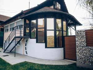 a house with a gazebo with a staircase on it at Villa Marta in Kanjiža