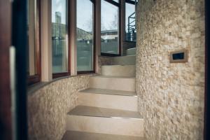 a set of stairs in a building with windows at Villa Marta in Kanjiža