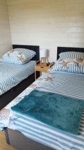 Postel nebo postele na pokoji v ubytování Zakątek Dębki