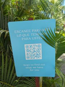 a sign in front of a palm tree at 2bedroom Grand luxxe in Nuevo Vallarta 