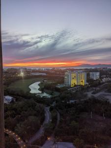 a sunset over a city with a river and buildings at 2bedroom Grand luxxe in Nuevo Vallarta 