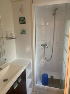 a bathroom with a shower with a blue stool at Mobilhome in Azur