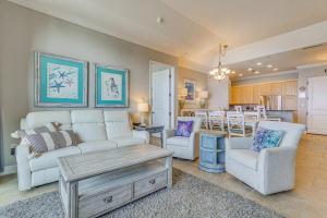 a living room with a couch and chairs and a kitchen at Pensacola Beach Penthouse with View and Pool Access! in Pensacola Beach