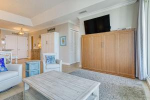 a living room with a couch and a table at Pensacola Beach Penthouse with View and Pool Access! in Pensacola Beach