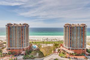 two tall buildings next to the beach and the ocean at Pensacola Beach Penthouse with View and Pool Access! in Pensacola Beach