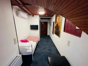 a hallway with two beds in a room at Broken bed hootel in Kaunas