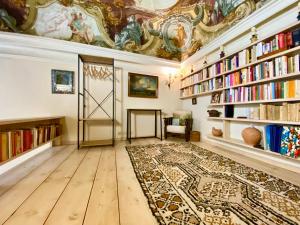 a library with bookshelves and a door with a rug at Venice Palace Luxury Suites in Venice