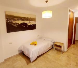 1 dormitorio con 1 cama y una foto en la pared en Awesome central house with 3 bedrooms, en Ceuta