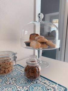 a plate of donuts on a counter with a glass display at Acasadelpescatore in San Benedetto del Tronto
