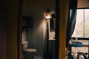 a bathroom with a toilet and a sink and a window at Beachfrontguesthouse in Puerto Escondido +67 photos