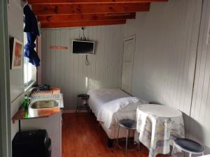 een kleine kamer met een bed en een wastafel bij Hostal Saint Michell. El Quisco in El Quisco