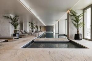 a lobby with a pool of water in a building at Bayline- Beachfront and Pool in Armação de Pêra