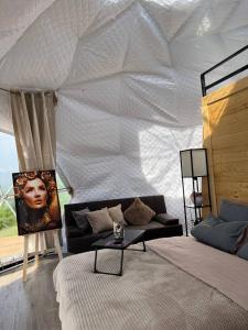 a living room with a couch and a white ceiling at Dilijan Glamping in Dilijan