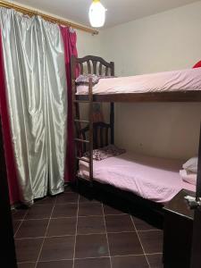 a room with two bunk beds and a window at Porto Matrouh Chalet X Rent family only in Marsa Matruh