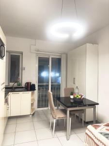 a kitchen and dining room with a table and chairs at Cozy Central Apartment - Swieqi in Is-Swieqi